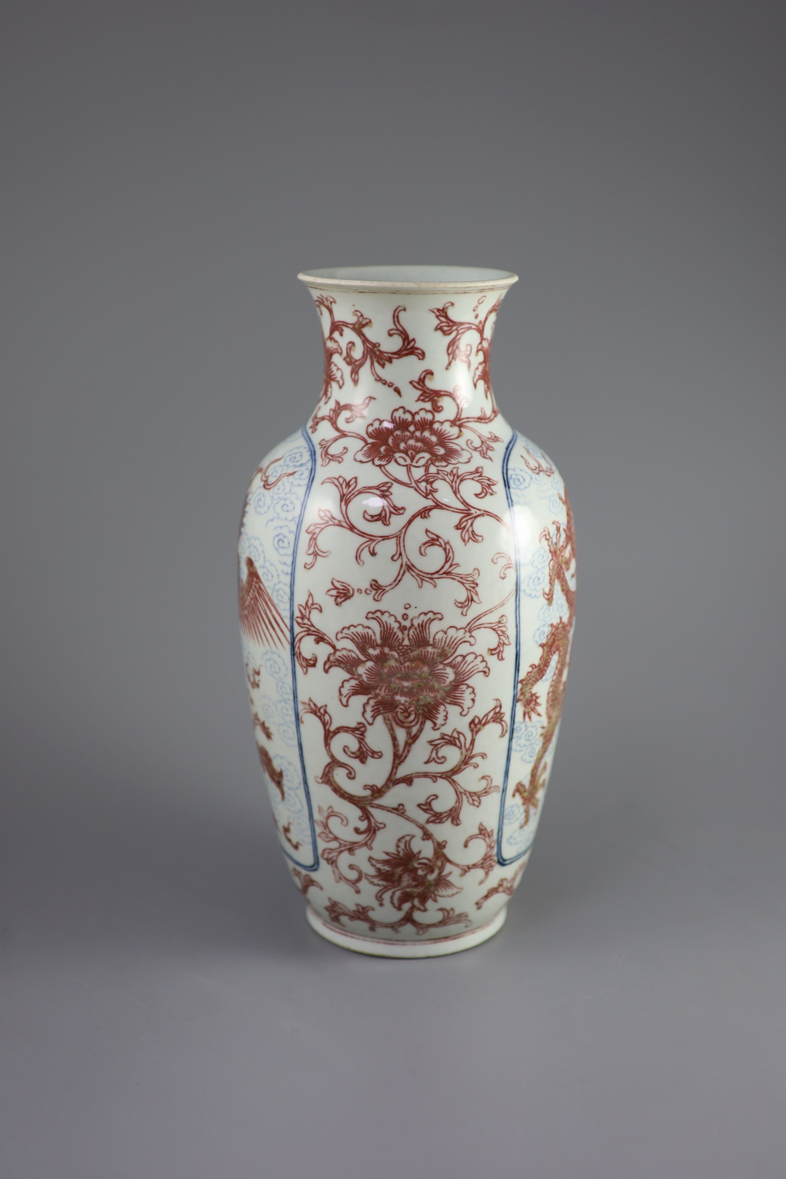 A Chinese underglaze blue and copper red 'dragon and phoenix' vase, Daoguang period (1821-50), 36cm high, rim ground off